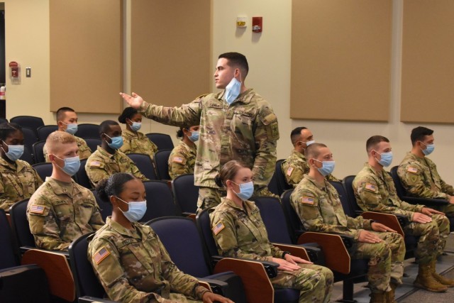 Pfc. Mason Calhoun, introduces his Family members during the Advanced Individual Training graduation ceremony for 56M, religious affairs specialist, of class 21-007 on May 13. (Photo by Mel Slater)