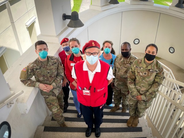 Volunteers from the Vicenza chapter of the Italian Relief Corps of the Order of Malta, American Red Cross, and staff members of the USAHC-Vicenza gather for a group photo during a small break from vaccinating the host nation professionals, May 25, 2021.