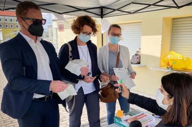 Staff from the Caserma Ederle branch of the Banca Nazionale del Lavoro check-in with Georgia Zantedeschi  from USAG Italy Safety Office to receive their first dose of the Pfizer vaccine from the Staff from USAHC-Vicenza, May 25, 2021.