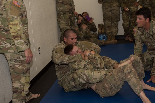 Staff Sgt. Richard Mendez, 53rd Quartermaster Company, 61st Quartermaster Battalion, applies a rear choke on his opponent during combatives.  Six Soldiers and NCOs from across the 13th Expeditionary Sustainment Command participated in the 2021 Best Warrior Competition May 23-26. (U.S. Army photo by Sgt. 1st Class Kelvin Ringold)