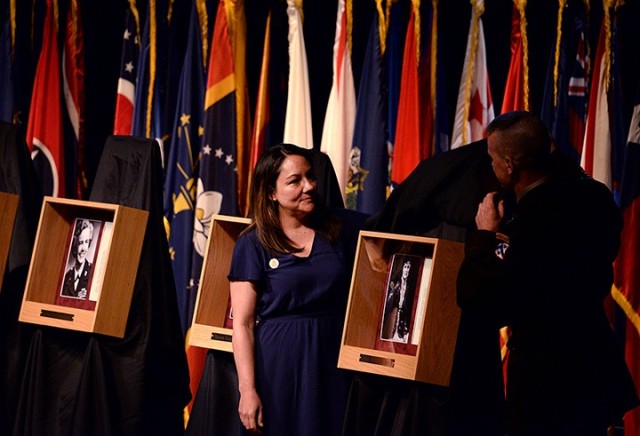 Heather Alvarado, Fort Leavenworth Spouses’ Club president, and Maj. Gen. Donn Hill, deputy commanding general for education, Combined Arms Center, unveil Elizabeth Schenck-Smith's Fort Leavenworth Hall of Fame portrait during the Hall of Fame...
