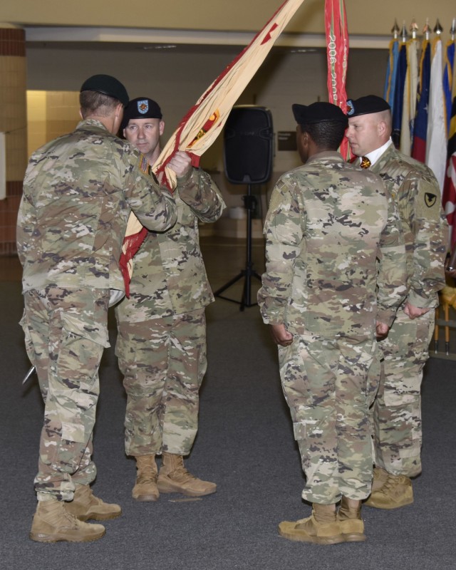 Lt. Col. Stephan Bolton, Hunter Army Airfield garrison commander, passes the garrison guidon to Command Sgt. Maj. Ryan C. Reichard, Hunter Army Airfield senior enlisted leader, during a change of responsibility ceremony, May 25. (Photo by Chris Rich)