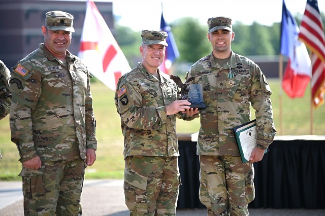 Staff Sgt. Ryan Columbare, a 42R musician and winner of the Combined Arms Support Command’s Noncommissioned Officer of the Year title, is congratulated by Maj. Gen. Rodney D. Fogg, CASCOM and Fort Lee commanding general, and Command Sgt. Maj....