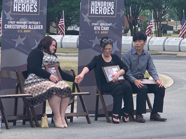 Jennifer Allgaier and Cathy Chay, Gold Star family members and survivors, hold hands during an emotional moment at the Tunnel to Tower ceremony at the Airborne and Special Operations Museum in Fayetteville, N.C., May 18. 
...