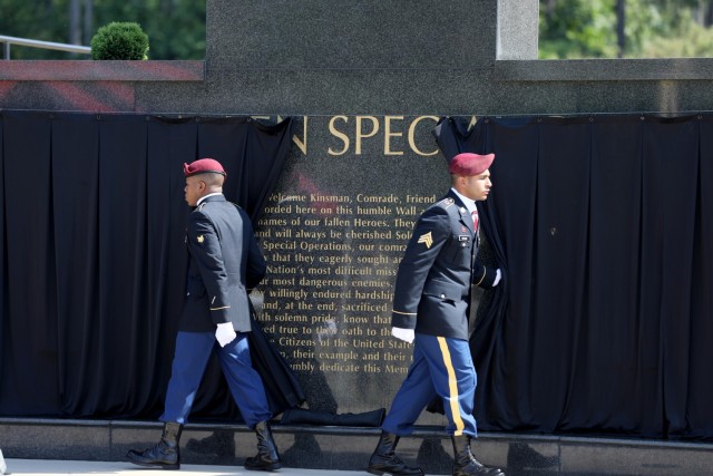 Command Sgt. Maj. Marc Eckard (left), USASOC, command sergeant major and Lt. Gen. Francis M. Beaudette (right), USASOC, commanding general salute following the wreath laying during a USASOC memorial ceremony on May 27, 2021.  

(U.S. Army photo by: Spc. Ramon Wright)