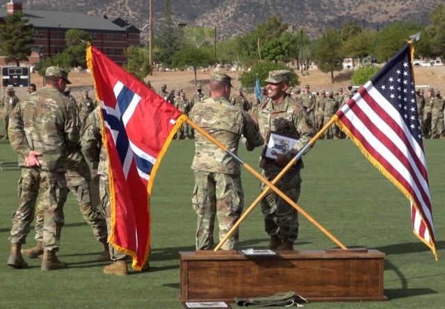 Leaders from Co. C, 309th Military Intelligence Battalion, U.S. Army Intelligence Center of Excellence honor Soldiers who earned the Norwegian Foot March Badge at Fort Huachuca, Ariz.