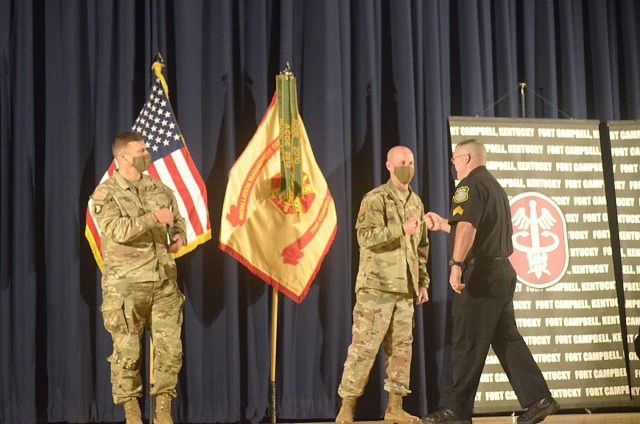 Samuel LaCrosse, lead police officer, fist bumps Command Sgt, Maj. Joseph Harbour, garrison senior enlisted adviser, May 21 as he is presented with the Civilian of the Year award at Wilson Theater. LaCrosse was recognized in the leader category....