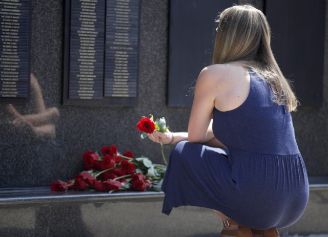 A Gold Star Family Member places a rose on the USASOC Memorial Wall at the conclusion of a memorial ceremony on May 27, 2021. A Gold Star Family member is someone who has lost an immediate family member in the line of duty while serving in the military. 

(U.S. Army photo by: Cpl. RJ Batts)