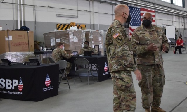 WIESBADEN, Germany – Staff Sgt. Nkruma Alladin explains to Brig. Gen. Jed Schaertl how the blood donor stations are set up and what the Army Reserve Soldiers are doing at each station.