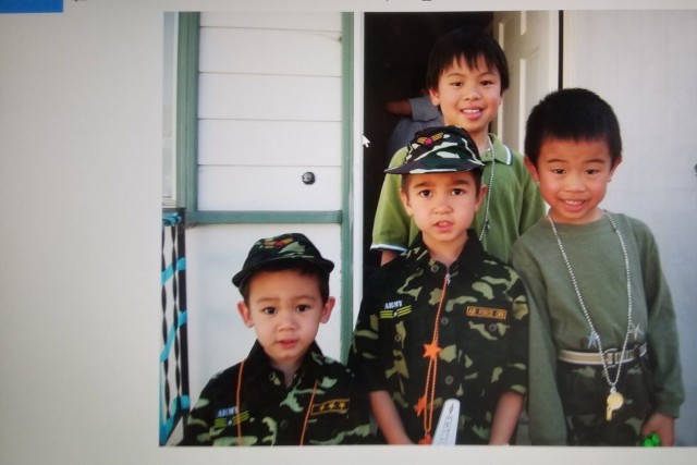 Specialist Ryan Do (far right), Headquarters and Headquarters Battery, 101st Division Artillery, 101st Airborne Division (Air Assault), as a child with his older brother Nathan (back) and cousins Kai (left) and Cole (center). Do dressed up as a...
