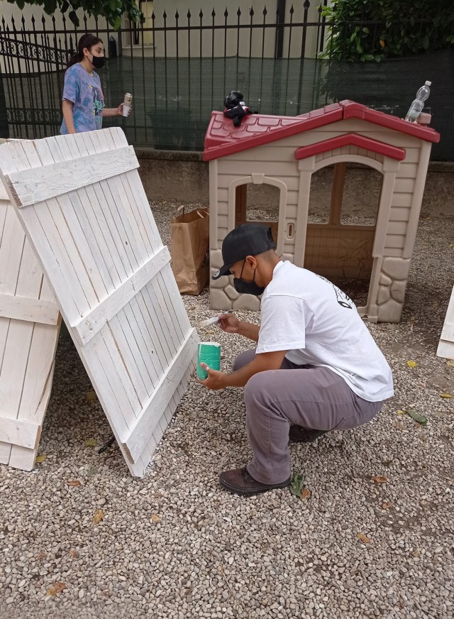 VICENZA, Italy: Sgt. Jesse Padilla, Better Opportunity for Single Soldiers president, repaints a fence at the kindergarten school in Quinto Vicentino May 22, 2021. Approximately 20 volunteers from the Vicenza military community painted wood fences on both sides.