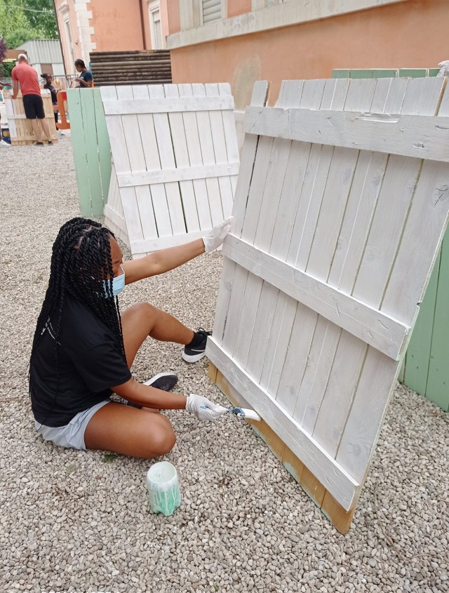 VICENZA, Italy: Better Opportunity for Single Soldiers volunteer Sgt. Jonel Knight repaints a fence at the kindergarten school in Quinto Vicentino May 22, 2021. She arrived here a couple months ago and she has already contributed her time within the community. Approximately 20 volunteers from BOSS, Vicenza Sergeant Morales Club and other Vicenza military community members participated in the project.