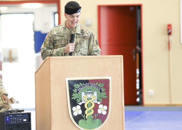 U.S. Army Col. Andrew Landers, commander, Landstuhl Regional Medical Center, provides remarks during a change of command ceremony where U.S. Army Lt. Col. Elizabeth Gum relinquished command of U.S. Army Health Clinic Baumholder (BAHC) to U.S. Army Lt. Col. Mark Jones at Baumholder, May 26. U.S. Army Health Clinic Baumholder provides ambulatory care for Soldiers, their families, and others, and offers acute and chronic care of pediatric and adult patients, physical examinations, health-related career screening and immunizations, non-operative gynecological diagnosis and treatment, minor surgical procedures and surgical follow-up and newborn care. Baumholder Army Health Clinic also provides specialty care services to include behavioral medicine, pharmacy, optometry, radiology and physical therapy.