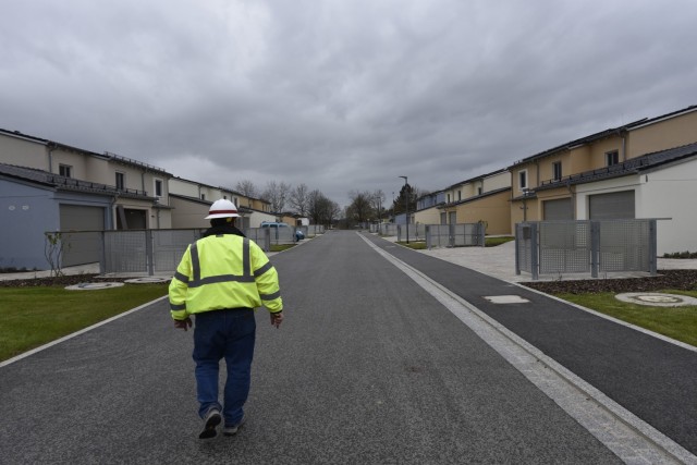 U.S. Army Corps of Engineers, Europe District Project Engineer John Taylor walks down a new street past several recently completed and nearly completed homes May 6, 2021 in the Kittenberg Housing Area on Rose Barracks in Vilseck, Germany, which is part of U.S. Army Garrison Bavaria. The U.S. Army Corps of Engineers is delivering 29 family homes, including associated infrastructure like drainage, utilities and roads in a newly built neighborhood for Soldiers and their families. The homes are part of a larger, long-term collaboration between the U.S. Army Corps of Engineers and the garrison to provide new and renovated family housing and other quality of life projects for Soldiers and their families at Rose Barracks.