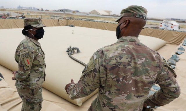Pvt. 1st Class Kenya Davis, a petroleum supply specialist, 526th Composite Supply Company, 541st Combat Sustainment Support Battalion, 1st Division Sustainment Brigade, explains the capabilities for the fuel supply point to Command Sgt. Maj. Kevin...