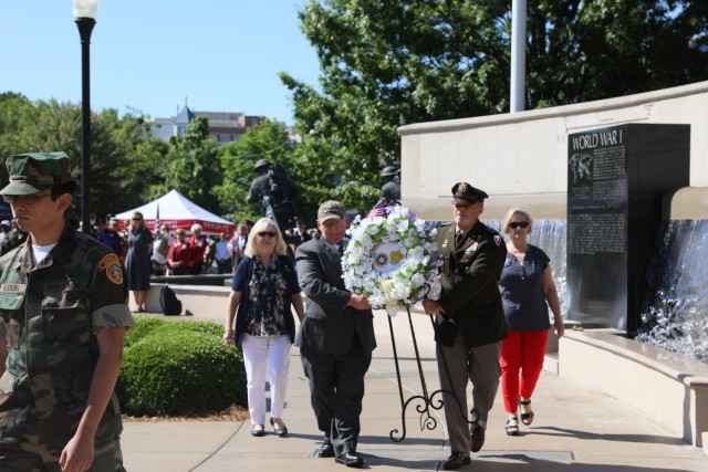 The Gold Star wreath is carried to its place of honor during the May 31, 2021, Huntsville Memorial Day Ceremony at the Huntsville/Madison County Veterans Memorial by Medal of Honor recipient and retired Capt. Mike Rose and Army Materiel Command’s Deputy Commander and Redstone Arsenal Senior Commander Lt. Gen. Donnie Walker. Walking with them are, Gold Star mothers, from left, Lydia Scott and Annette Hall. A member of the Young Marines escorts the group.

