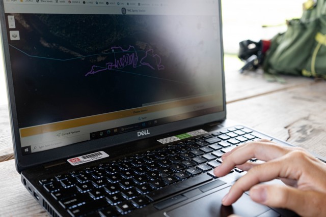 Jessica Fair, U.S. Army Corps of Engineers, biologist demonstrates how the Spray Tracker Platform developed by FWC’s Andrew Dew detects and collects the spray path of the licensed applicators out in the field in real time