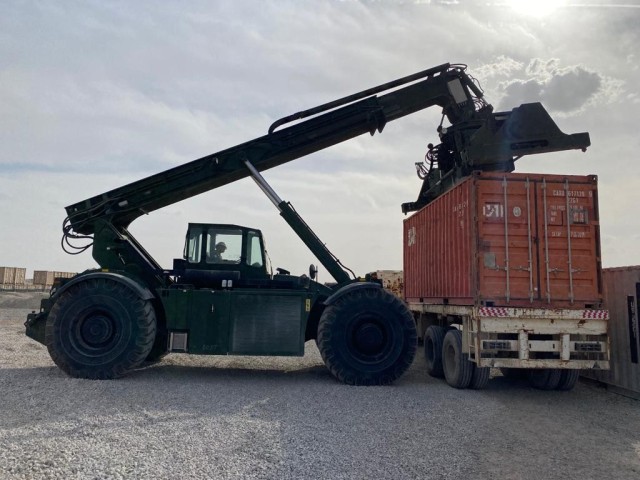 A Erbil Forward Logistics Element Soldier loads a containers for onward movement and divestment to regional partners on Erbil Air Base, in Erbil, Iraq, on May 5, 2021.