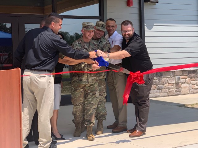 Col. Scott Pence, Fort Bragg Garrison commander (center), and Fort Bragg team members cut the ribbon signifying the official grand opening of the Smith Lake Outdoor Recreation Center and the re-opening of the beach at Smith Lake Recreation Area, May. 26.