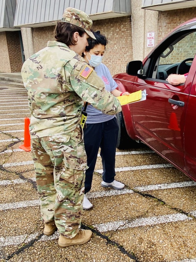 Maj. Ellen Jones and Marivel Clayton discuss patient concerns before administering the first dose of the Moderna COVID-19 vaccine during the drive-thru COVID-19 vaccination event on May 22. 