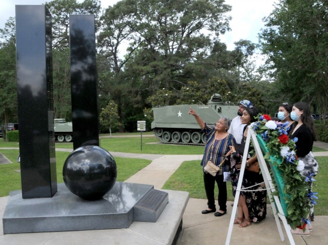 Juanita Colunga, Gold Star Mother of Spc. Zeferino Colunga, points out her son’s name on the Global War on Terrorism Memorial Monument in Fort Polk’s War Memorial Park to other members of her Family following a Memorial Day Ceremony May 27.