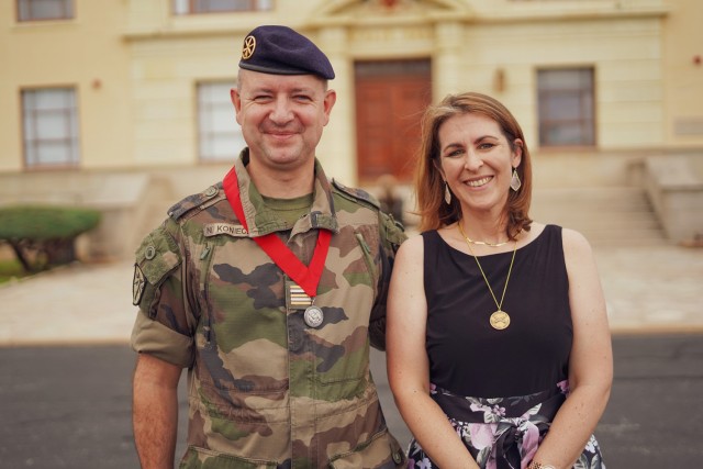 Lt. Col. Nicolas Konieczny and his wife, Magali, pose for a photo following a recent awards ceremony in front of McNair Hall. Konieczny, the French field artillery liaison officer to the Fires Center of Excellence received the Order of Saint...