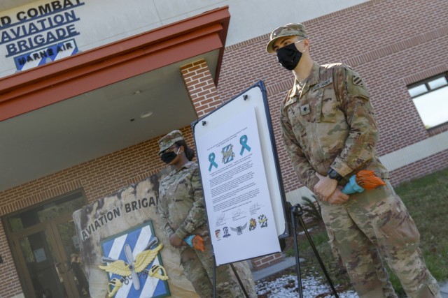 Representatives of the Marne Air Advisory Board, Pvt. Kelle Ross (left) and Spc. Cameron Forte (right), assigned to the the 3rd Combat Aviation Brigade, 3rd infantry Division, stand next to the sexual assault awareness and prevention proclamation, Apr. 27 at Hunter Army Airfield, Georgia. The theme, “protecting our people protects our mission,” emphasizes how every service member, regardless of rank, can encourage behaviors that foster a climate of dignity and respect, and in doing so, help ensure readiness to complete the mission.