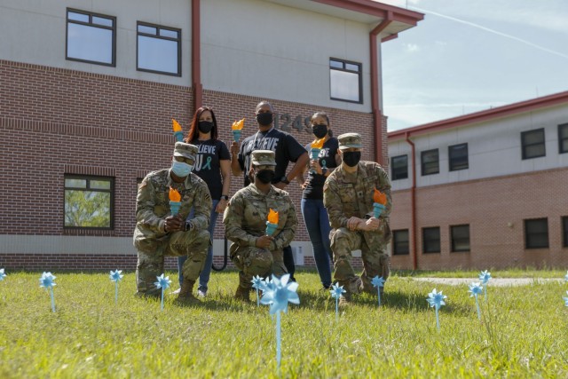 The 3rd Combat Aviation Brigade Sexual Assault Response Coordinators, Victim Advocate, and representatives of the Marne Air Advisory Board stand behind teal pinwheels, Apr. 27 at Hunter Army Airfield, Georgia. Teal is the official color of sexual assault awareness and prevention month, and the pinwheels are a symbol of sexual violence prevention.