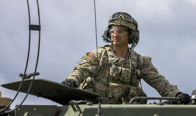 A U.S. Army Soldier assigned to Alpha Battery, 1st Battalion, 77th Field Artillery Regiment, 41st Field Artillery Brigade, monitors vehicle movement while preparing for a  rapid infiltration high mobility artillery rocket system live-fire exercise...