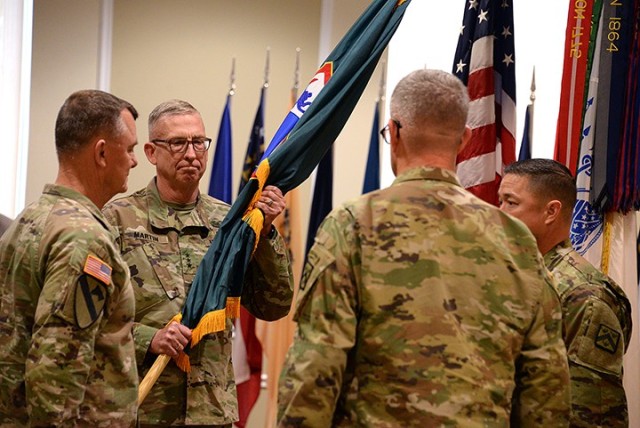 Incoming Combined Arms Center and Fort Leavenworth Commanding General Lt. Gen. Theodore Martin accepts the colors from Gen. Paul Funk II, commanding general of Training and Doctrine Command, to pass them back to CAC Command Sgt. Maj. Stephen...