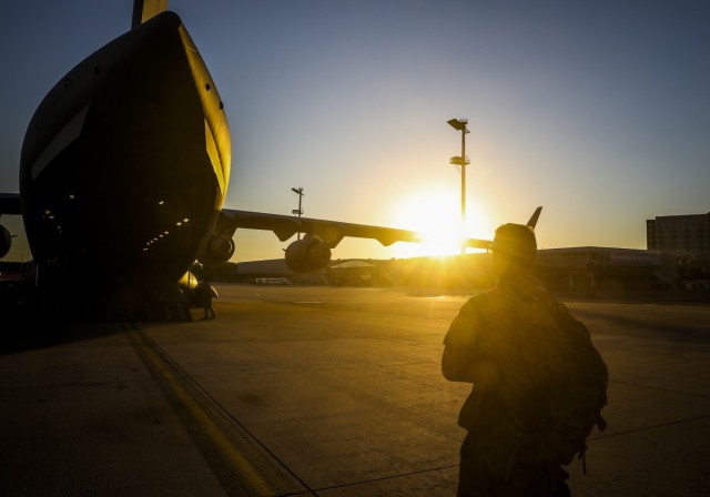 A U.S. Army Soldier assigned to Alpha Battery, 1st Battalion, 77th Field Artillery Regiment, 41st Field Artillery Brigade, looks at the C-17 aircraft, belonging to the 1-64th Air Wing Tennessee Air National Guard, 
that brought him home after Saber Guardian, at Ramstein Air Base, Germany, June 1, 2021. Saber Guardian 21 involved a rapid infiltration high mobility artillery rocket system live-fire that is a sub-exercise of Defender 21, a 7th Army Training Command-led, U.S. Army Europe and Africa-directed exercise designed to increase readiness, lethality and interoperability by exercising allied and partner nations’ ability to integrate joint fires in a multinational environment at both the operation and tactical levels. (U.S. Army photo by Spc. Zack Stahlberg)