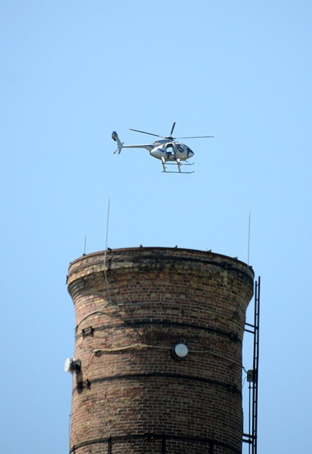 Sgt. 1st Class Jason Anderson, Headquarters and Headquarters Company, 40th Military Police Battalion (Detention), rides in a Kansas City Police Department helicopter to help search for an "escaped inmate" from the air during an escaped inmate...