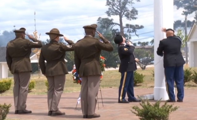 Post Command Sgt. Maj. Philson Tavernier, Staff Sgt.
Josiah Bartz and Brig. Gen. Milford H. 'Beags' Beagle Jr, Fort Jackson
commander salute as the flag is lowered during the Memorial Day ceremony at
Centennial Park May 31. (Screenshot)