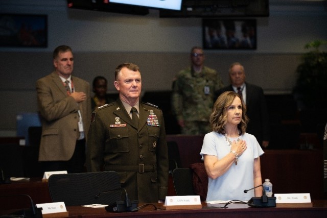 Gen. Paul E. Funk ll and Dr. Elizabeth Funk stand for the playing of the national anthem during the memorialization ceremony at Fort Eustis, Virginia, May 27, 2021.