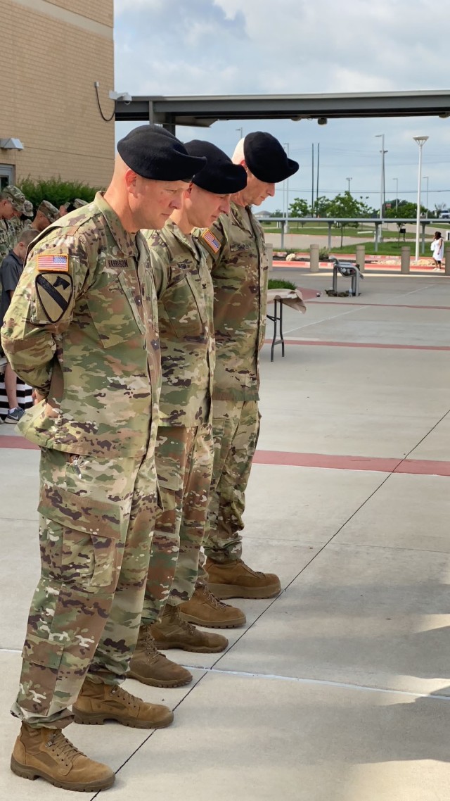Lt. Col. Scott Harrison, outgoing troop commander; Col. Richard Malish, commander of Carl R. Darnall Army Medical Center; Lt. Col. Jody Shipley pause for chaplain's blessing during CRDAMC's Troop Command change of command ceremony on Prichard Field May 28.