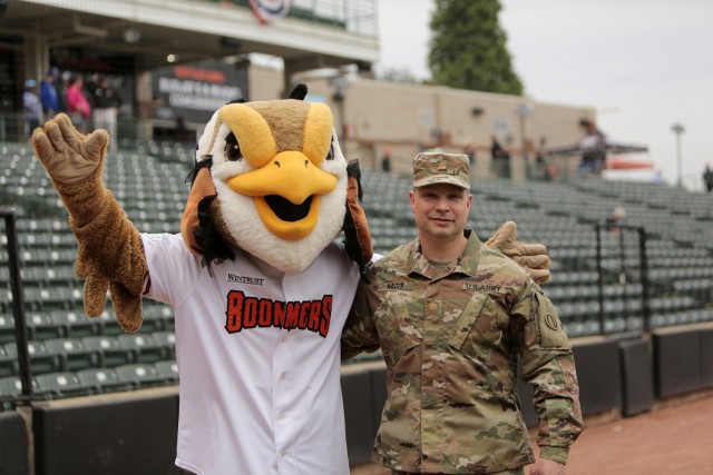 Maj. Scott Hager, Headquarters and Headquarters Company commander for the 85th U.S. Army Reserve Support Command, pauses for a photo with “Coop”, the Mascot for the Schaumburg Boomers baseball team, before the Boomers Memorial Day home game vs. the Gateway Grizzlies at Wintrust Field, May 31, 2021. Hager threw out the ceremonial first pitch before the game.
(U.S. Army Reserve Photo by Anthony L. Taylor)