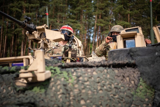 1st Lt. Matthew Homsy, Abrams tank commander, 2nd Battalion, 8th Cavalry Regiment, 1st Armored Brigade Combat performs a radio communications check before maneuvering his tank platoon to its battle position during exercise Iron Wolf in Rukla,...