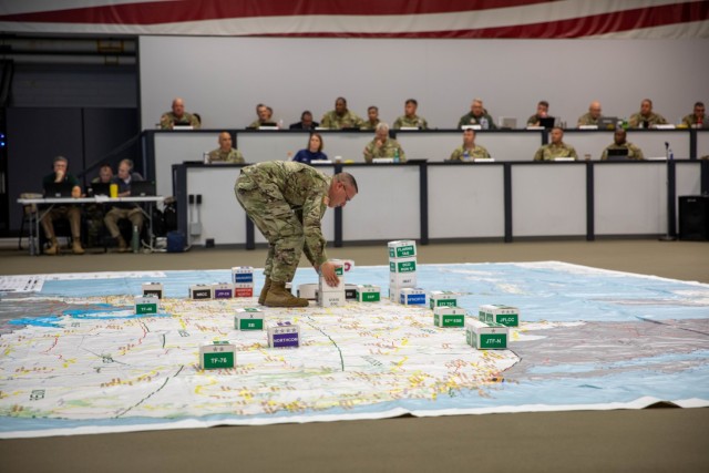 Maj. Kenneth Andrews, a U.S. Army North logistics plans officer, places markers on the 2021 Hurricane Rehearsal of Concept Drill map to identify positions of supporting military units during the aftermath of multiple simulated hurricanes in the...