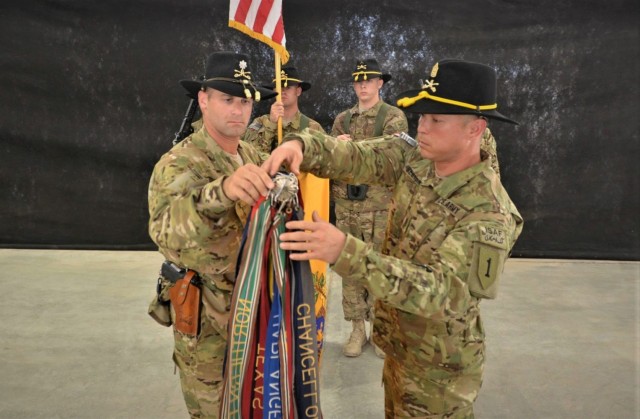 Lt. Col. Matthew Weinshel and Command Sgt. Maj. Stephen Helton, Task Force Saber, 1st Combat Aviation Brigade, 1st Infantry Division, unfurl the squadron’s colors and assume mission responsibility during a transition of authority ceremony on Kandahar Airfield Aug. 29, 2013. (U.S. Army photo by Capt. Andrew Cochran/released)