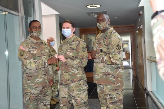 Lt. Gen. R. Scott Dingle, the U.S. Army Surgeon General and Commander of the U.S. Army Medical Command and MEDCOM Command Sgt. Maj. Diamond Hough talks with Sgt. Albina Gallagher, the non-commissioned officer in charge of primary care at the...