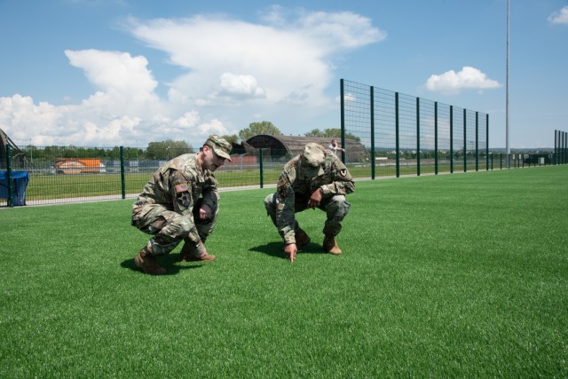 From left to right, U.S. Army Corps of Engineers, Europe District commander Col. Patrick Dagon, U.S. Army Col. Mario A. Washington, Garrison Commander, U.S. Army Garrison (USAG) Wiesbaden inspect the new artificial turf field located at Clay North in Lucius D. Clay Kaserne, June 4, 2021. The turf field is the latest sports addition for U.S. Army Garrison Wiesbaden and is located next to the Family and Morale Welfare and Recreation Programs (FMWR) Recreation Center at Clay North. (U.S. Army photo by Alfredo Barraza)