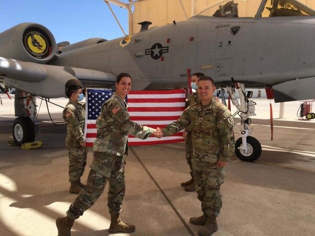 U.S. Army Lt. Col. Alissa McKaig, 2d Battalion, 13th Aviation Regiment commander, congratulates Staff Sgt. Brandon Smith on his reenlistment at Fort Huachuca, Arizona, May 19, 2021. 