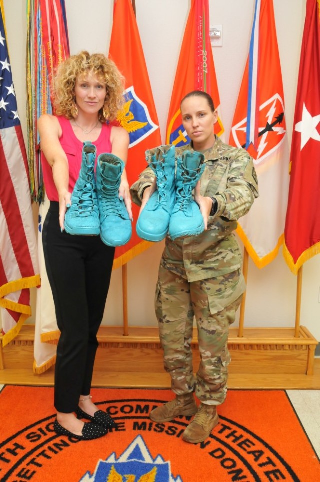 Sgt. 1st Class Alise Ashley, 311th SC (T) SARC (left), and Alyxandria Paslay (right), Victim Advocate for the 516th Signal Brigade, proudly display two of many "Teal Combat Boot,' displays created to further build awareness, support and advocacy for survivors of Sexual Assault and Sexual Harassment.