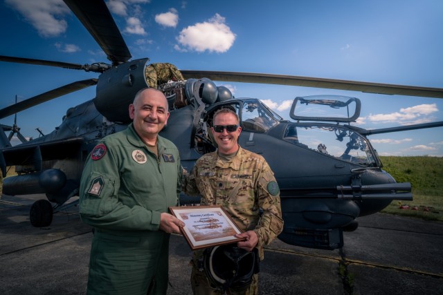 U.S. Army Lt. Col. Matthew Cole, the 1st Battalion, 3rd Aviation Regiment commander, receives a certificate in recognition of his first Mi-24 Hind flight from Hungarian Defense Force Col. Zoltán Rolukó at Szolnok airbase, Hungary, June 3, 2021, during exercise Saber Guardian 21, part of the DEFENDER-Europe 21 series of exercises.