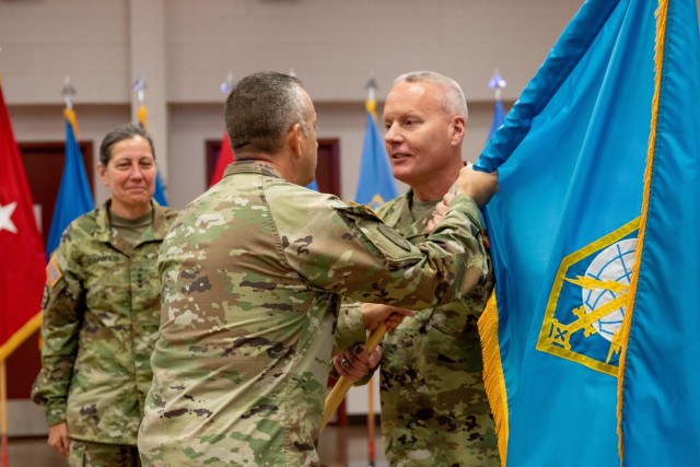 Military Intelligence Readiness Command (MIRC) Commanding General Brig. Gen. Joseph Dziezynski (right) passes the MIRC colors to Command Sgt. Major Brian Bertazon, MIRC senior enlisted leader, during the Military Intelligence Readiness Command's...