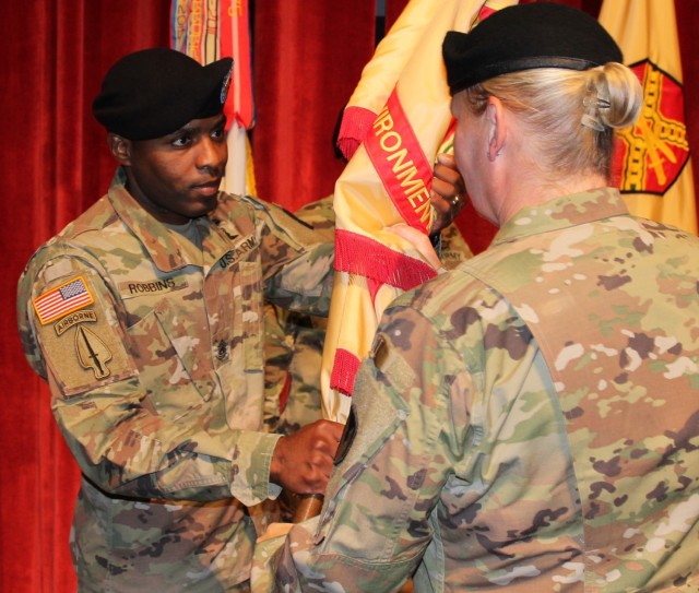 Col. Alicia M. Masson passes the U.S. Army Environmental Command guidon to Command Sgt. Maj. Tremayne A. Robbins during a Change of Responsibility Ceremony on June 10.