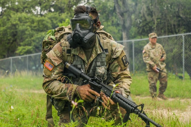 U.S. Army Spc. Justin Earnhart, 470th Military Intelligence Brigade, pulls security while wearing a joint service general purpose mask during an exercise in the Army Futures Command Best Warrior Competition on Fort Sam Houston, Texas, June 9 2021....
