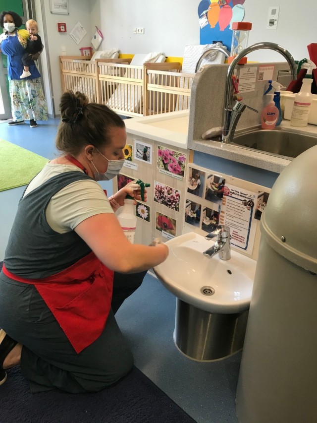 Joan Engel cleans the sink in the infant room at the end of the day.  All surfaces in the room are cleaned with soap and water and then sprayed with a sanitizing solution.