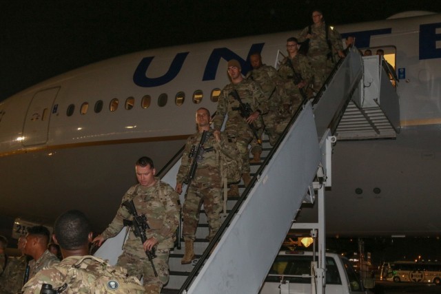 Soldiers with 1st Battalion, 28th Infantry Regiment, 3rd Infantry Division, depart an airplane at Yokota Air Base, Japan, June 8, 2021. These Soldiers will support Exercise Orient Shield 21-2 after completing a 14-day restriction of movement....