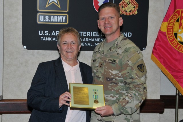 Maj. Gen. Darren Werner (right), Commanding General U.S. Army Tank-automotive and Armaments Command, and Marion Whicker (left), Executive Director TACOM&#39;s Integrated Logistics Support Center, display Whicker&#39;s Armed Forces Civilian Service Medal.  She received the medal during a TACOM Town Hall on Mar. 8 at the Detroit Arsenal, Michigan. 